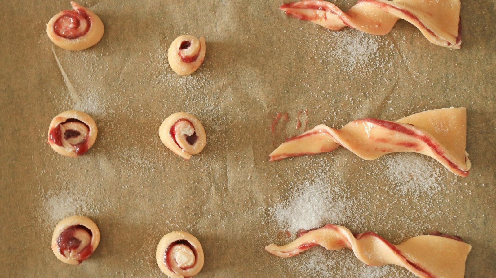 Pastry pinwheels and twists on a sheet tray.